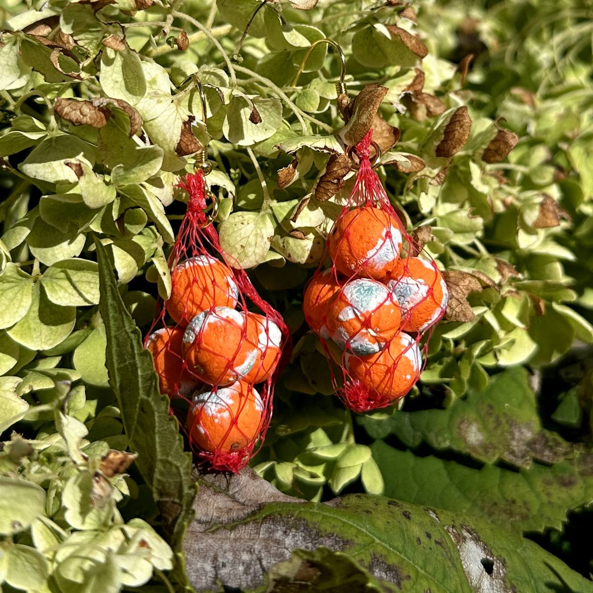 MOLDY ORANGE PRODUCE BAG EARRINGS