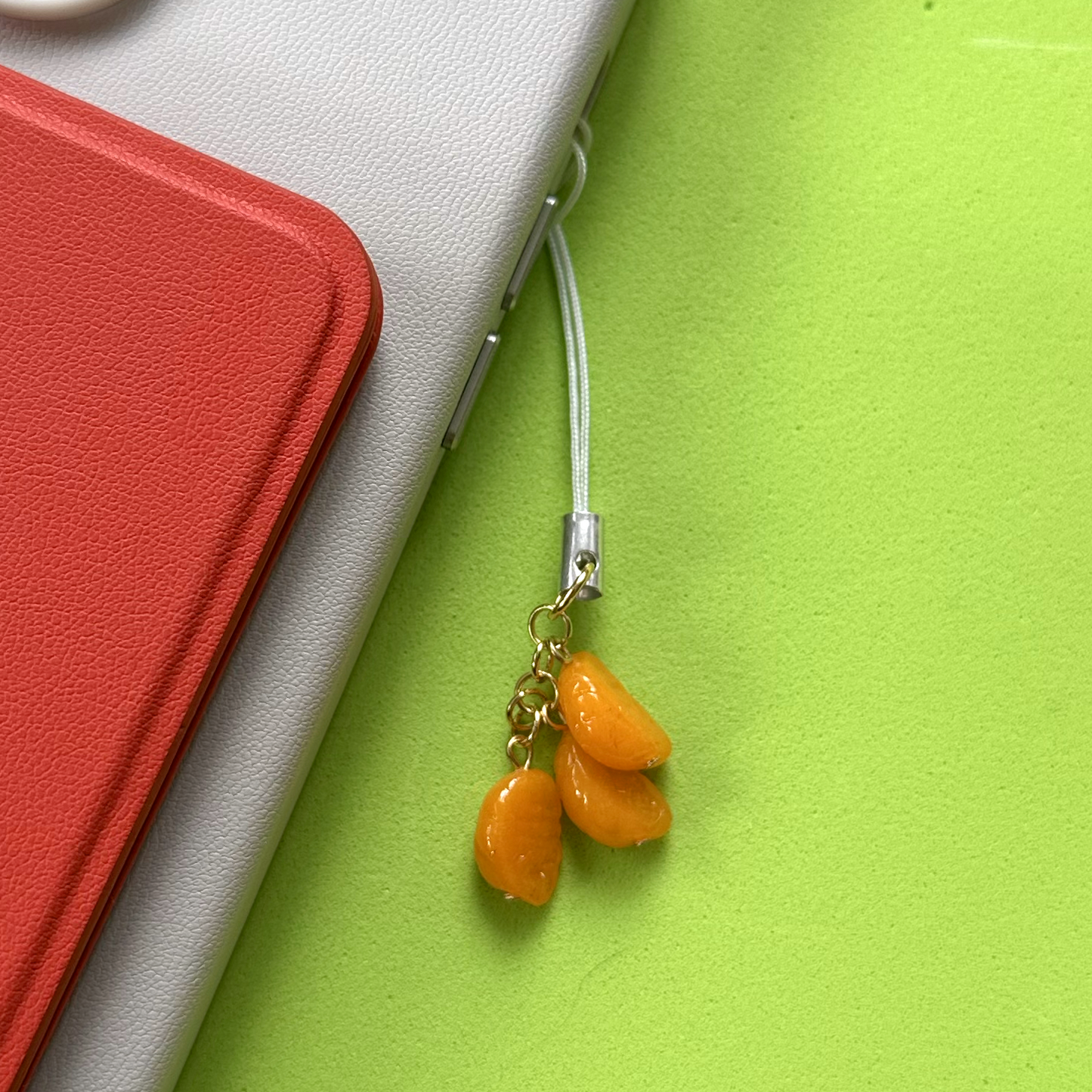 ORANGE WEDGE PHONE CHARM